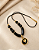 Colar de Cordão e Resina Preto com Pingente Coração Dourado - Imagem 2