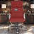 Cadeira Original Eames Presidente com Rodinhas Cromadas e Anti Risco Linha Capa em Madeira Vermelho - Imagem 2