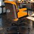 Cadeira Original Eames Diretor com Rodinhas Black e Anti Risco Linha Capa em Madeira - Laranja - Imagem 3