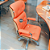 Cadeira Original Eames Presidente com Rodinhas Cromadas e Anti Risco Linha Capa em Madeira Escura ou Clara - Vermelho Telha - Imagem 2
