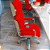 Cadeira Original Eames Presidente com Rodinhas Cromadas e Anti Risco Linha Capa em Madeira Escura ou Clara - Vermelho - Imagem 2