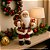 Papai Noel Decorativo Natalino 25cm com Casaco Xadrez Vermelho e Verde e Saco de Presentes Decorado - Imagem 3