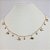 CHOKER FOLHEADO A OURO COM PENDURADOS EM ELEFANTES E PEDRINHAS - Imagem 1