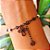 Pulseira em ródio negro com pérolas, flores e mini crucifixo - Imagem 3