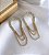 Brinco DOMINIQUE arco cravejado com zirconia e 3 fios folheada a ouro - Imagem 1