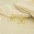 Brinco de Flor Vazada com Zircônia Banhado a Ouro 18k - Imagem 1