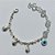 PULSEIRA FOLHEADA A PRATA COM 50 MILÉSIMOS + VERNIZ DIAMOND - PULSEIRA COM CRISTAIS, PINGENTES COM PALAVRA ABRAÇO E OLHO GREGO - TAMANHO: 19CM - PRA1006 - Imagem 1