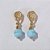 BRINCO FOLHEADO A OURO COM 6 MILÉSIMOS + VERNIZ DIAMOND  BASE DESENHADA CRISTAL ADLER 7MM OUBR000064 - Imagem 1
