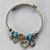 PULSEIRA (BRACELETE) EM AÇO INOXIDÁVEL - PULSEIRA COM BERLOQUES EM CORAÇÕES COM ZIRCÔNIAS E OLHOS GREGOS - ACPS000535 - Imagem 1