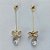 BRINCO FOLHEADO A OURO - BANHADO COM 5 MILÉSIMOS + VERNIZ DIAMOND - BRINCO DE PINO BOLINHA COM FIO E ZIRCÔNIAS 12MM - (OURO351) OUBR000258 - Imagem 1