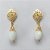 BRINCO FOLHEADO A OURO - BANHADO COM 5 MILÉSIMOS + VERNIZ DIAMOND - BRINCO DE PINO COM BASE VAZADA E PEDRA EM CRISTAL LEITOSO 12MM - (OURO392)OUBR000619 - Imagem 1