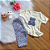 Conjunto Blusa Manga Curta Oncinha Off White e Calça Capri Bebê Lilás tamanho 3 a 6 meses - Imagem 1