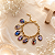 Pulseira Dourada em Corrente com 7 Medalhas Coloridas - Imagem 1