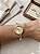 Relógio bracelete dourado fundo dourado - Imagem 1