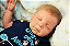 Bebê Reborn Menino Kyle 55 Cm Olhos Fechados Detalhes Reais Lindíssimo Acompanha Enxoval E Chupeta - Imagem 1