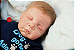 Bebê Reborn Menino Kyle 55 Cm Olhos Fechados Detalhes Reais Lindíssimo Acompanha Enxoval E Chupeta - Imagem 1