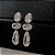Brinco de Pressão BP - Zircônias Cristal com Pingente Alongado - Luxo em Ouro 18K - Imagem 1