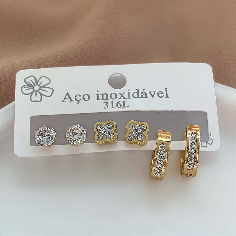 BRINCO KIT ARGOLINHA E TREVO ZIRCÔNIAS E PONTO DE LUZ DOURADO AÇO 316L⭐️