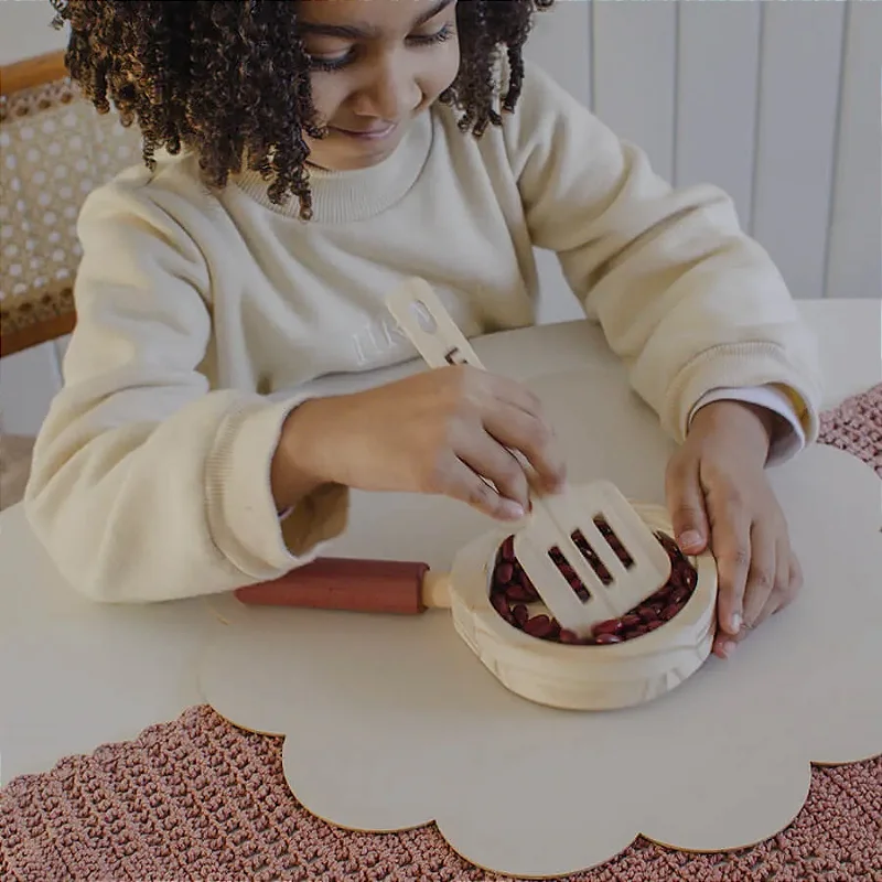 Menina brincando com a frigideira de madeira da Minicozinha Lume